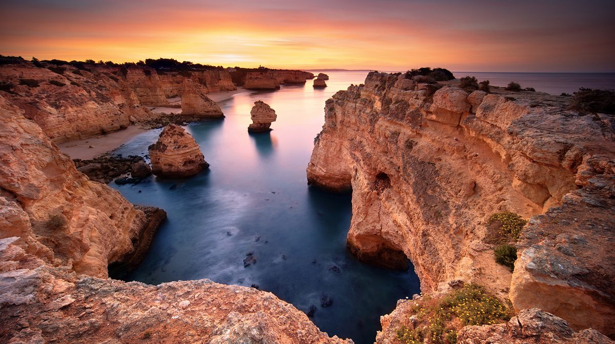 Long exposure waterscape photography shot during sunrise in Marinha Beach located in Algarve, Portugal